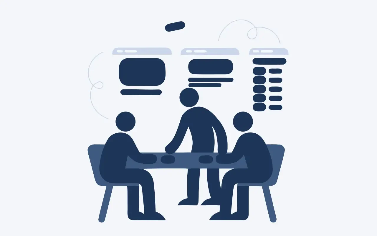 Tre persone in riunione attorno a un tavolo, con mockup di pagine web appesi alla parete.
